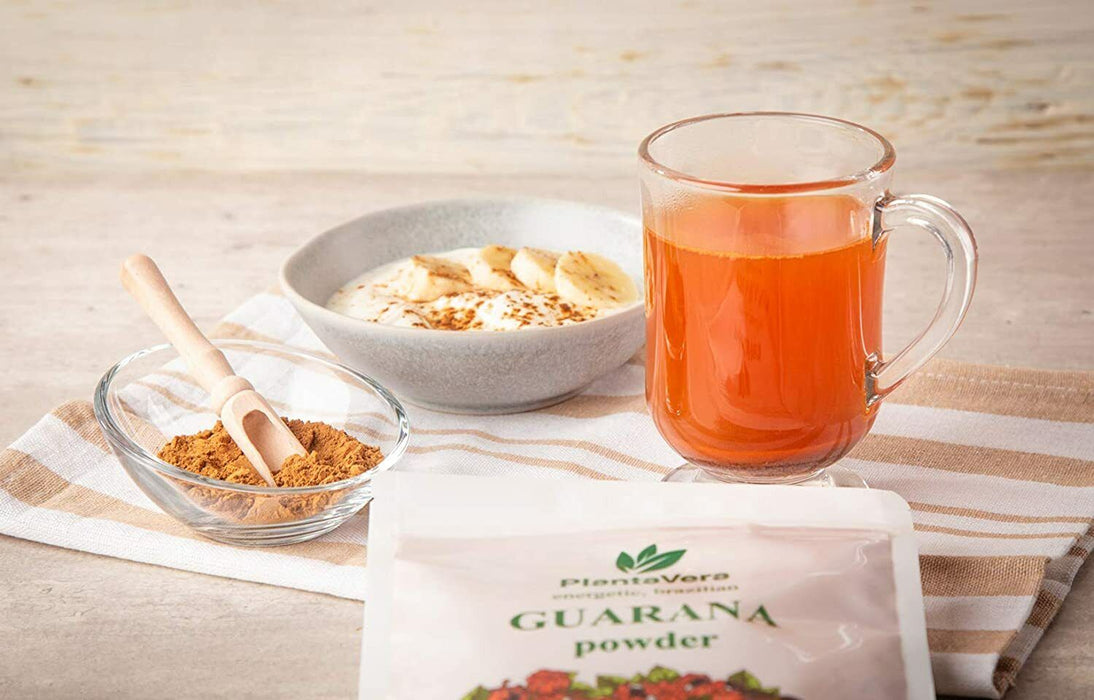 Eine Tasse Tee neben einer Packung Guarana-Pulver von PlantaVera, ideal für einen Energiekick.